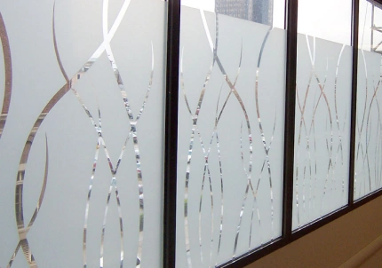 Frosted glass windows with a decorative etched pattern of curved lines, providing privacy while allowing light to pass through.